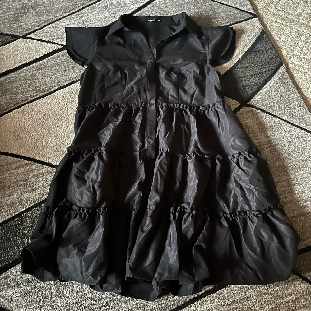 Black dress, never worn! Has buttons going down the front, and ruffles!